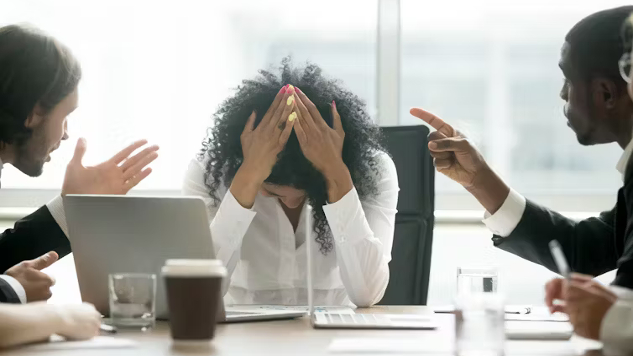 How Workplace Social Media Supports Employees Facing Toxic Bosses An office setting where employees are using workplace social media platforms